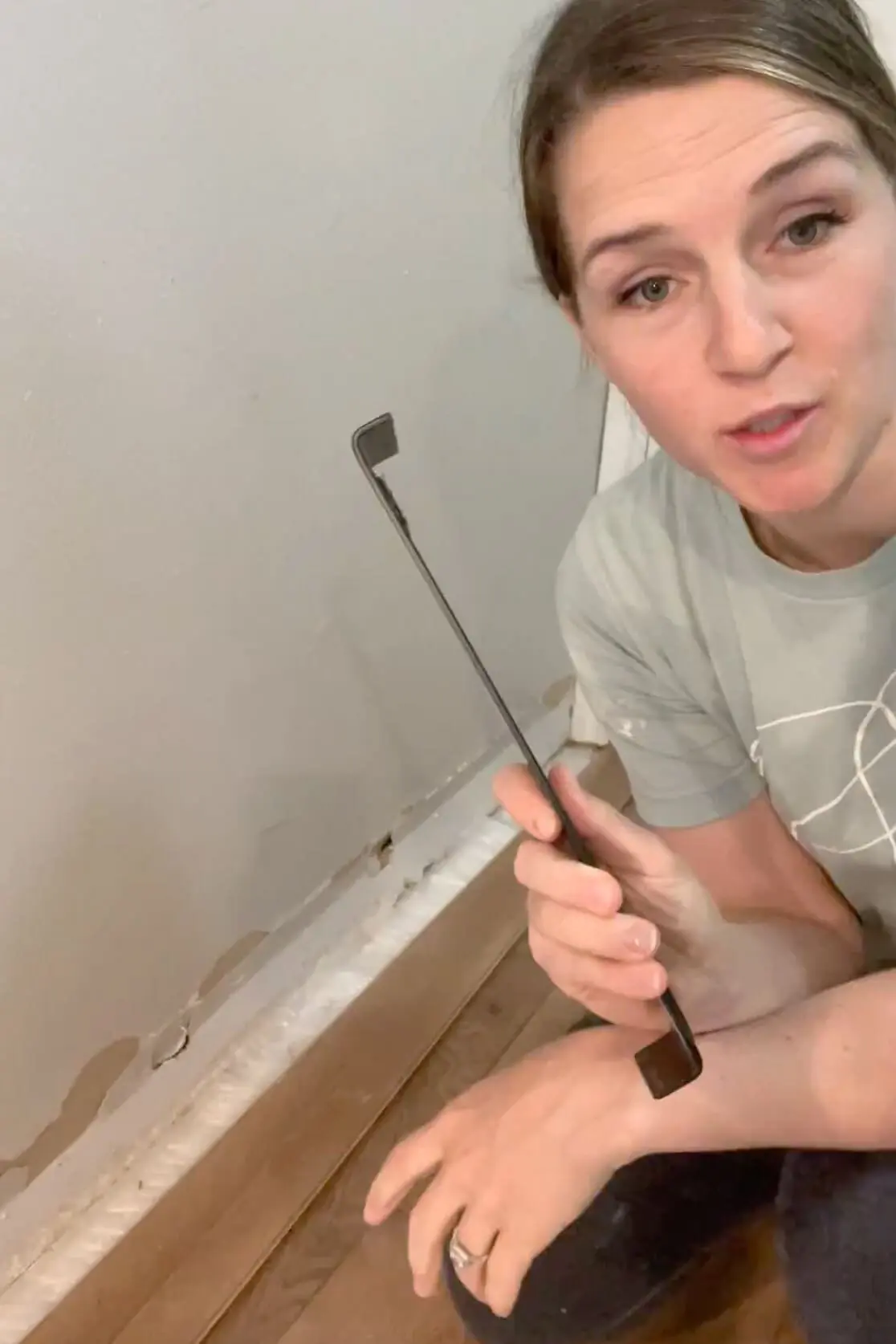 Using a pull bar to install laminate flooring. 